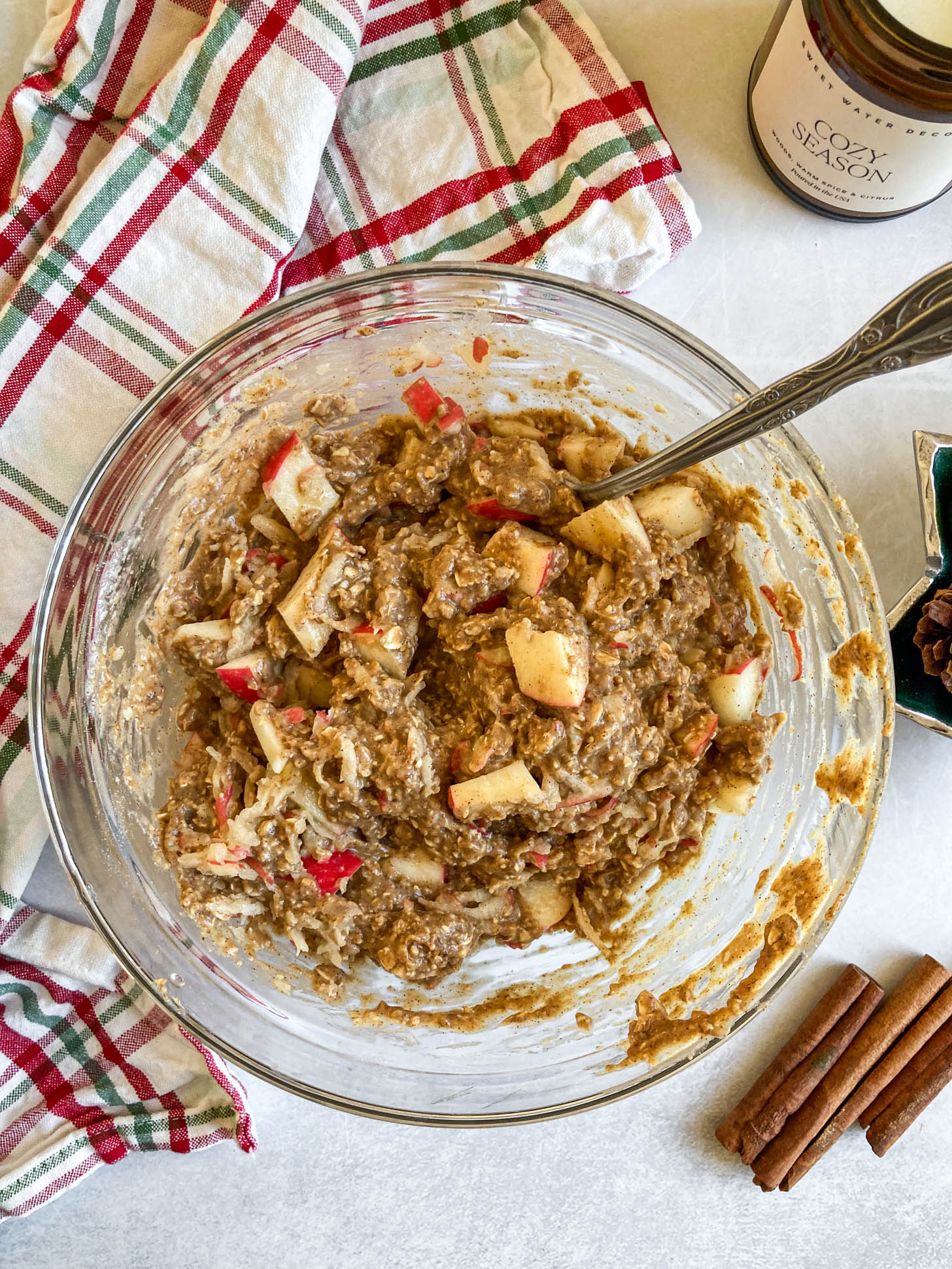 Loaf batter mixed in a bowl with apple slices.