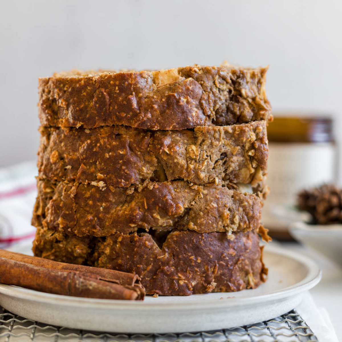 Apple cinnamon loaf slices stacked on a plate.
