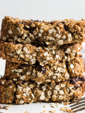 A stack of chocolate chip banana oatmeal bread slices.