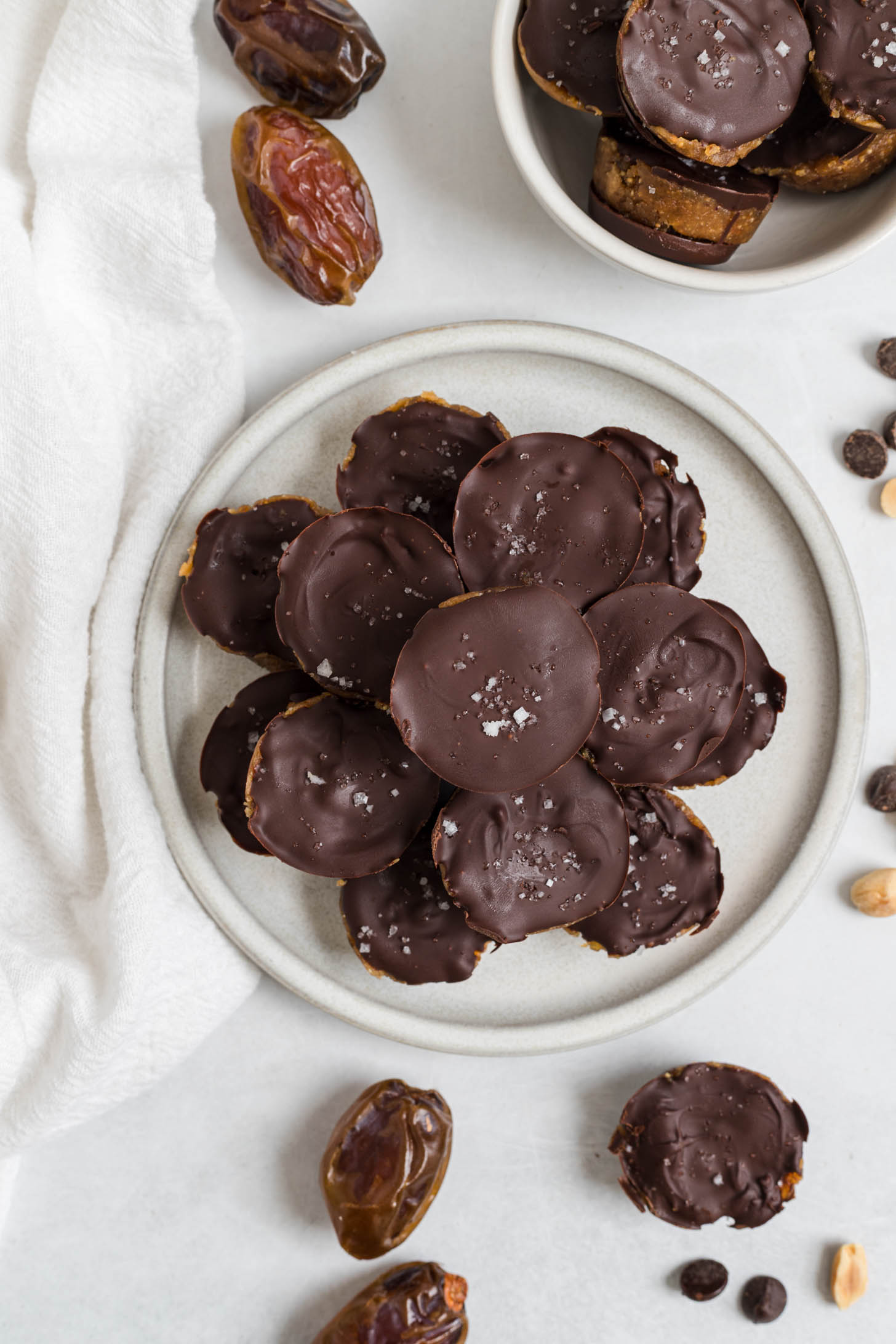 Peanut butter cups stacked on a plate.