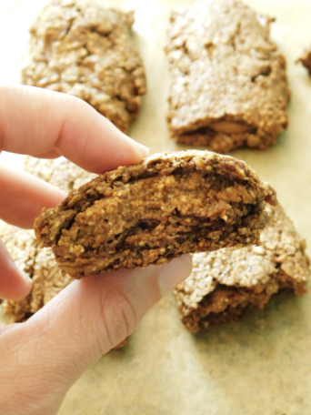 A close up of an Almond Butter Fig Bar that is cut in half.