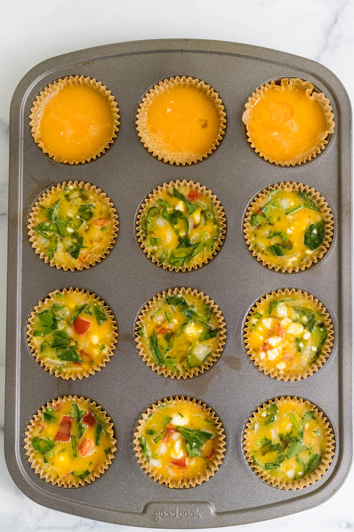 Muffin liners filled with egg mixture.