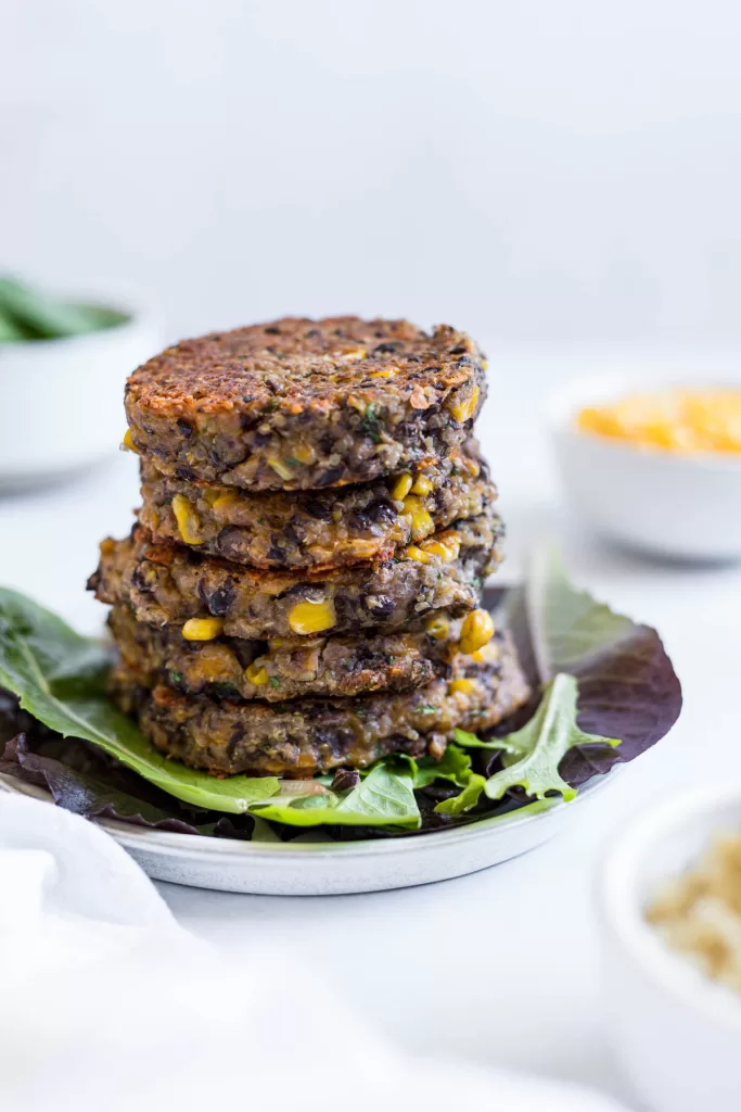 A stack of black bean fritters with quinoa.