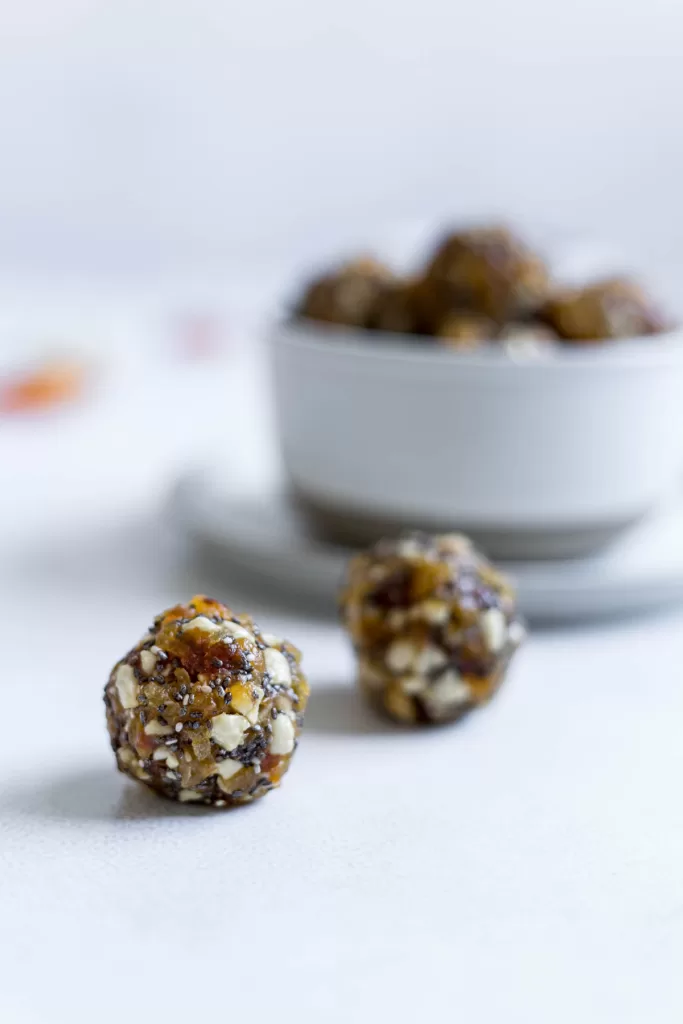 Two energy balls with a bowl of more balls sitting behind them. 