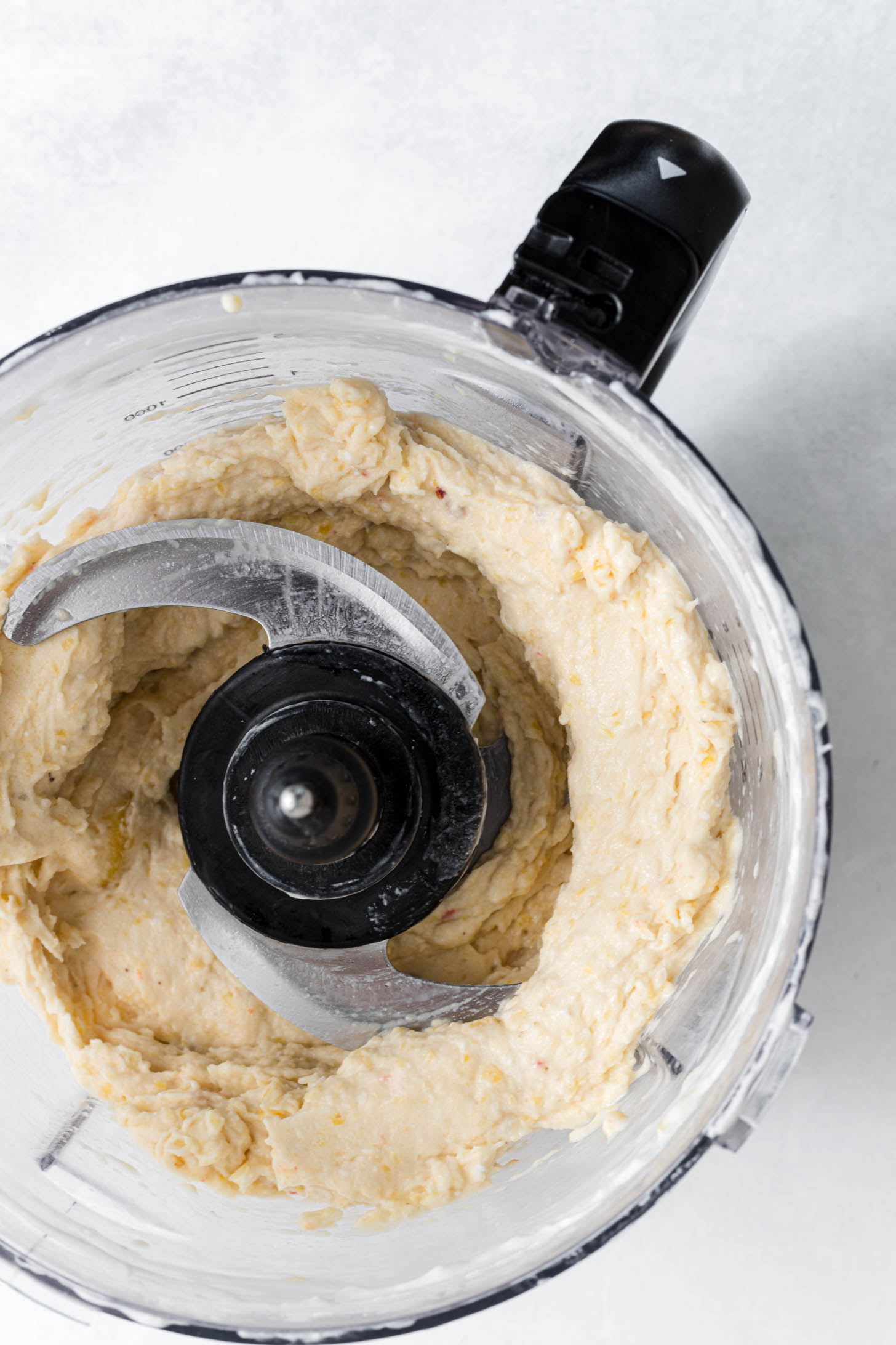 Peach nice cream processed in a food processor.