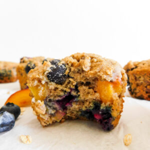 A blueberry nectarine muffin with a bite out of it.