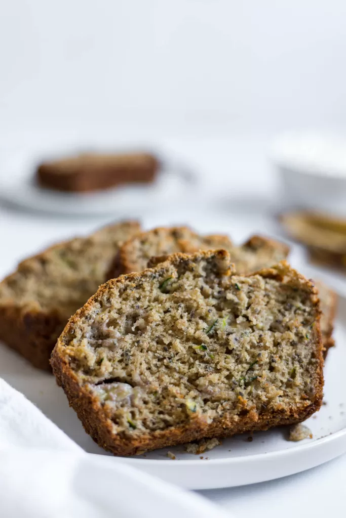 A close up look at a slice of zucchini banana bread.