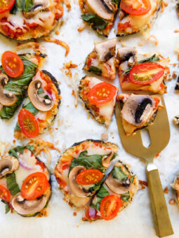 Eggplant pizzas with a serving utensil.