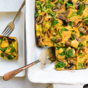 A baking dish with Potato Frittata With Caramelized Onions and a plate with a serving of the frittata.