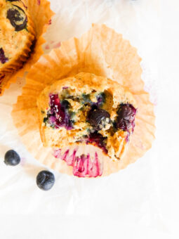 A Vegan Blueberry Muffin with a bite out of it.