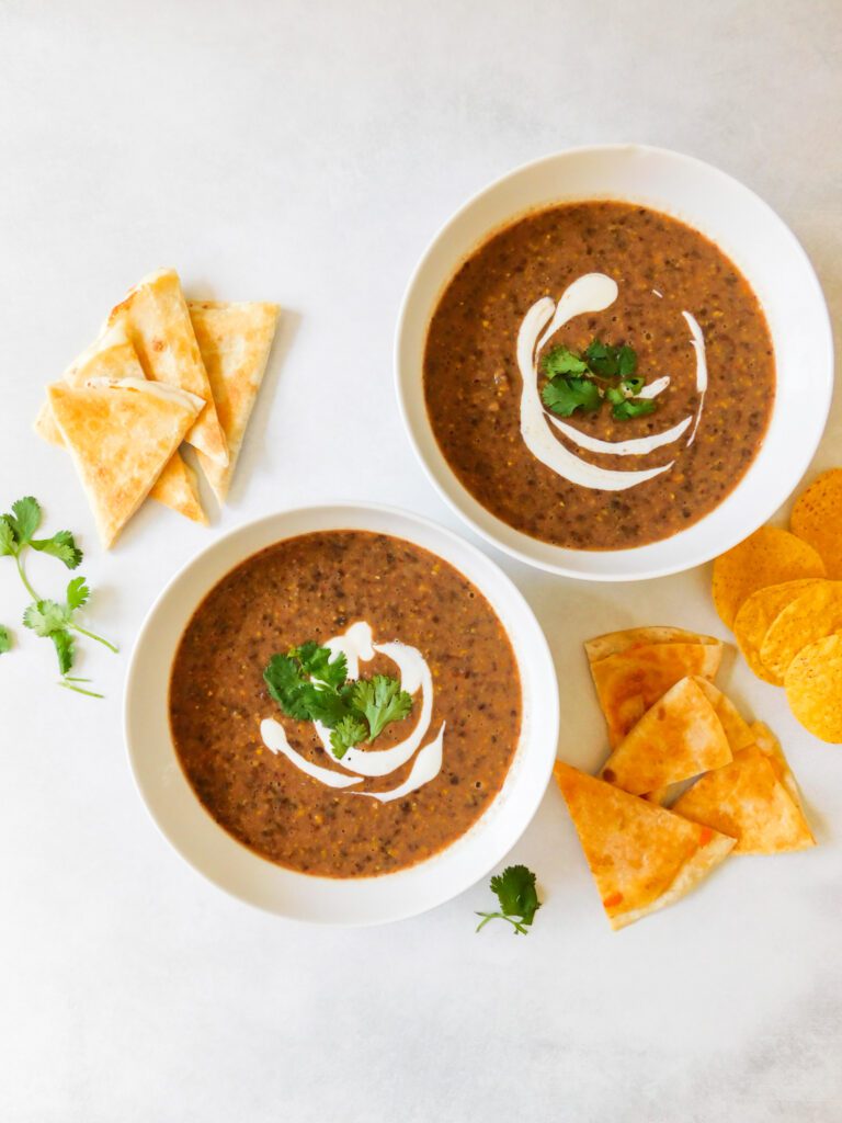 Two bowls of black bean and corn soup.