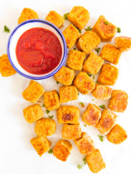 A group of Sweet Potato Tots with ketchup on the side.