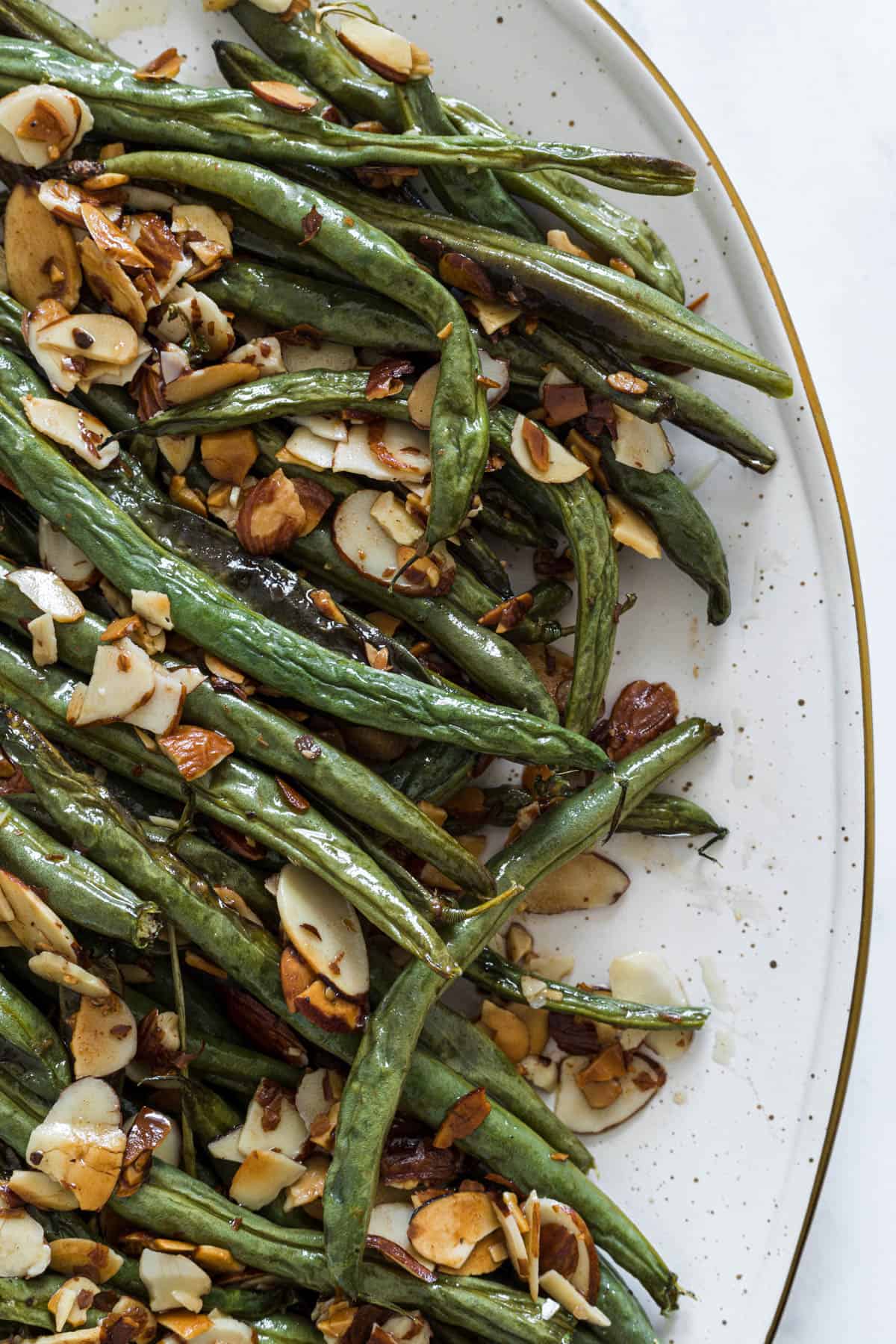 A close up view of green beans on a plate.