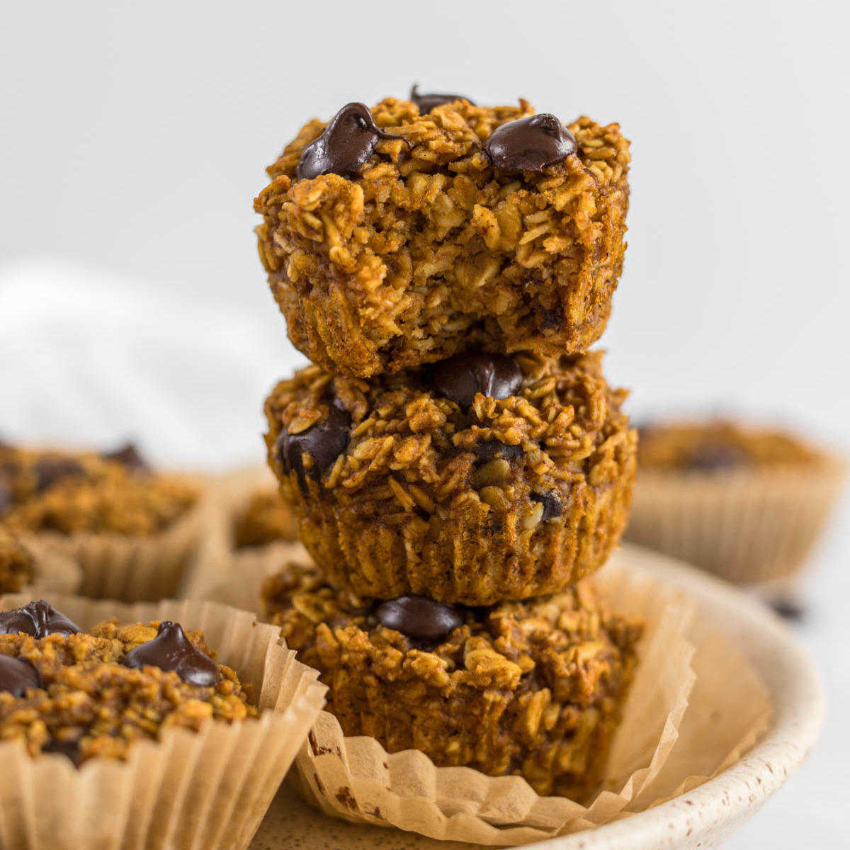 Pumpkin oatmeal muffins in a stack.