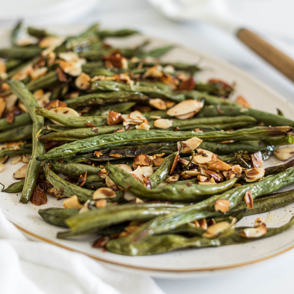 Roasted green beans on a plate.