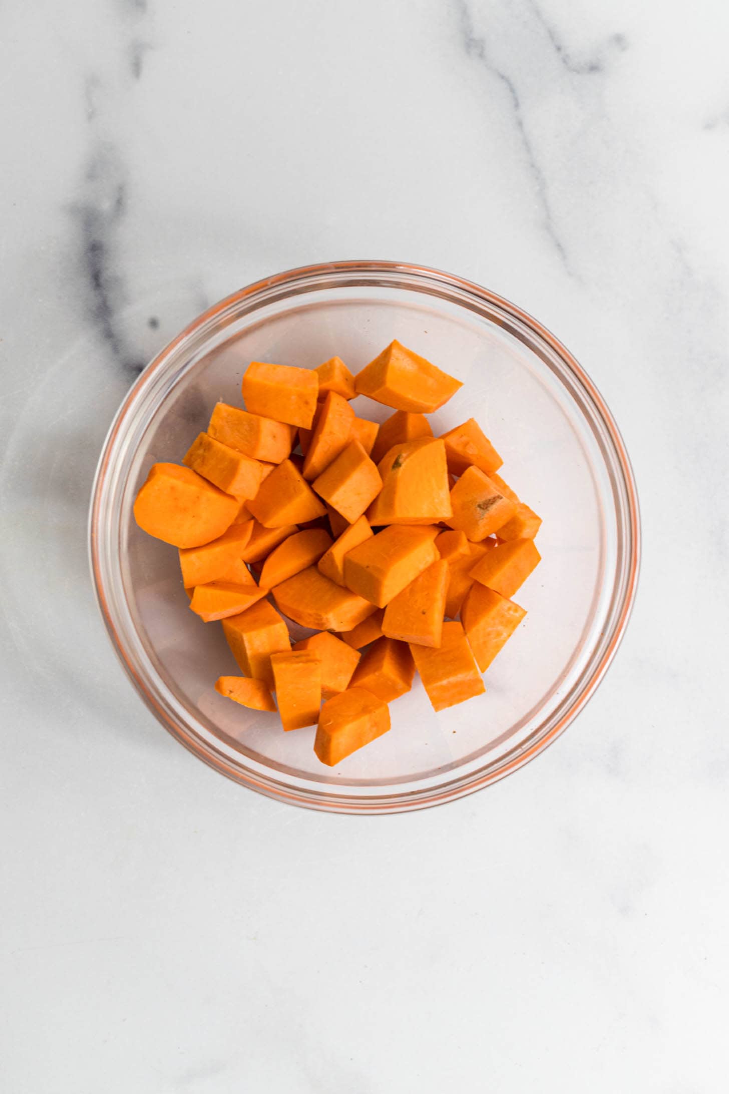 A bowl of cooked sweet potato diced.