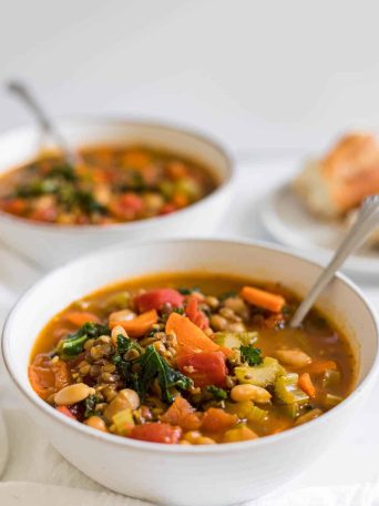 Two bowls of White Bean and Kale Soup With Lentils.