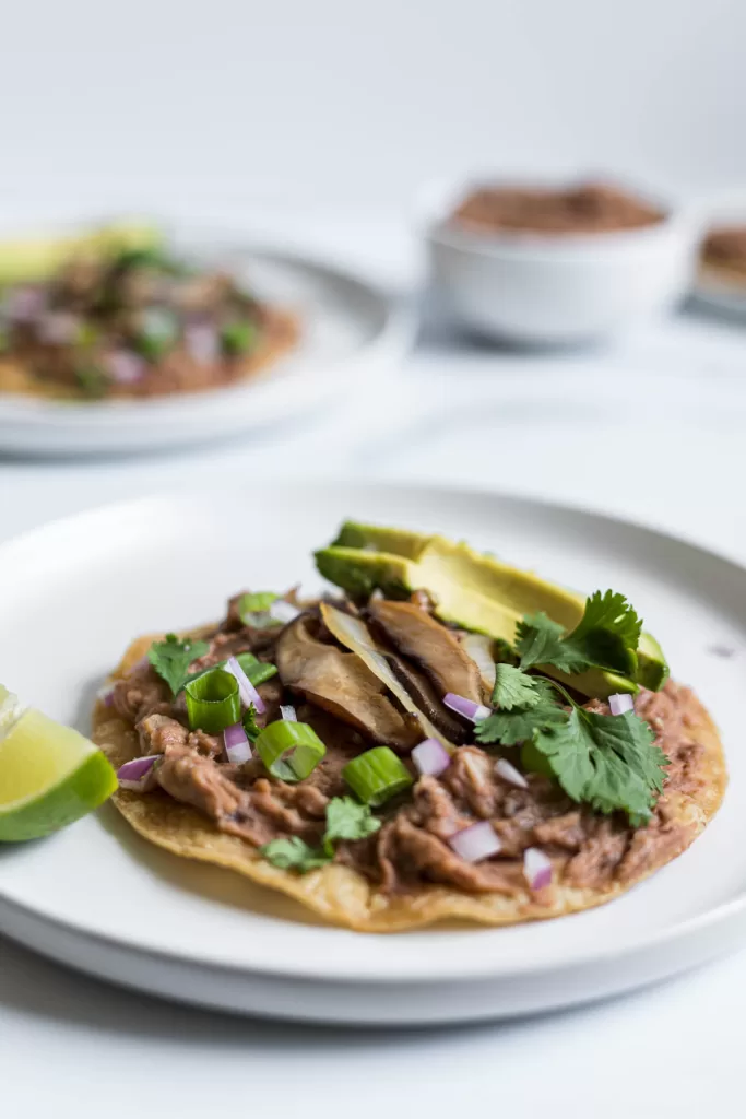 Side view of a plate with a mushroom tostada.