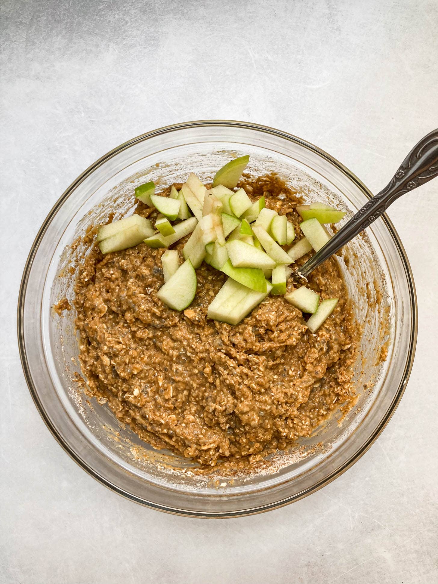 Dry and wet ingredients mixed together with diced apples.