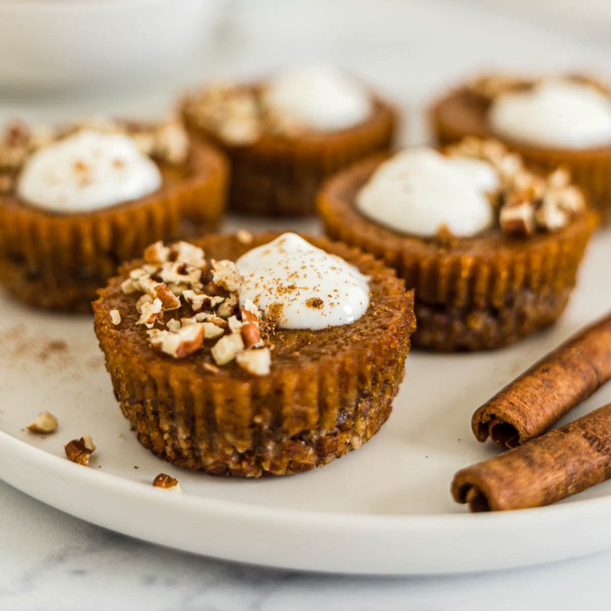 Mini pumpkin tarts on a plate.