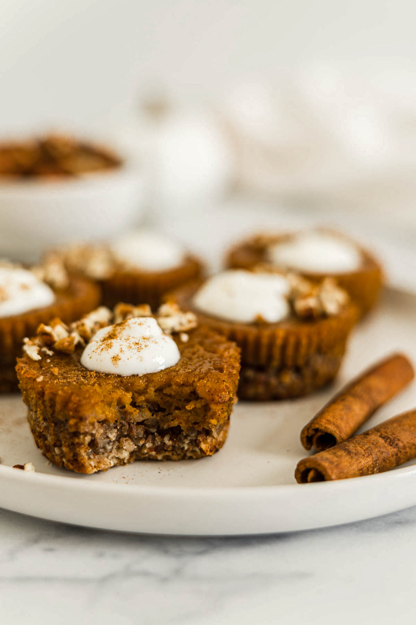 A pumpkin tart with a bite out of it.