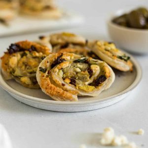 A small plate with Baked Mediterranean Puff Pastry Pinwheels.