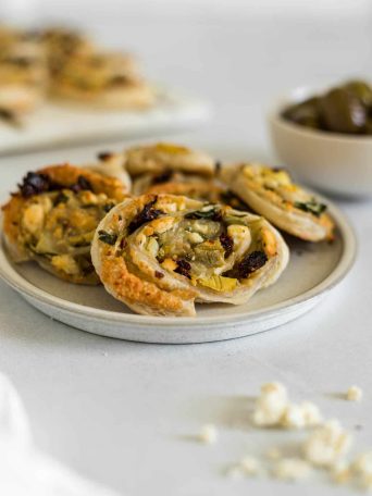 A small plate with Baked Mediterranean Puff Pastry Pinwheels.