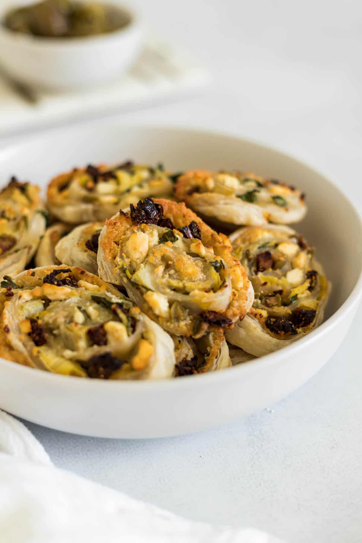 A bowl of baked pinwheels.