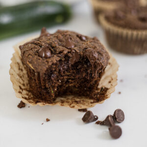 A Gluten-Free Chocolate Zucchini Muffin with a bite out of it.