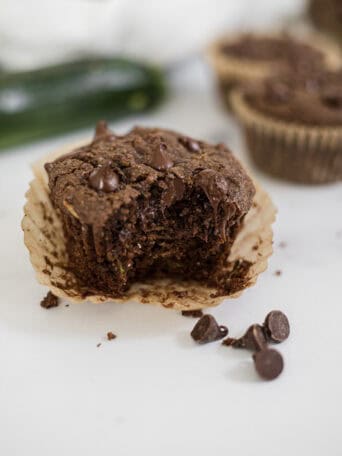 A Gluten-Free Chocolate Zucchini Muffin with a bite out of it.