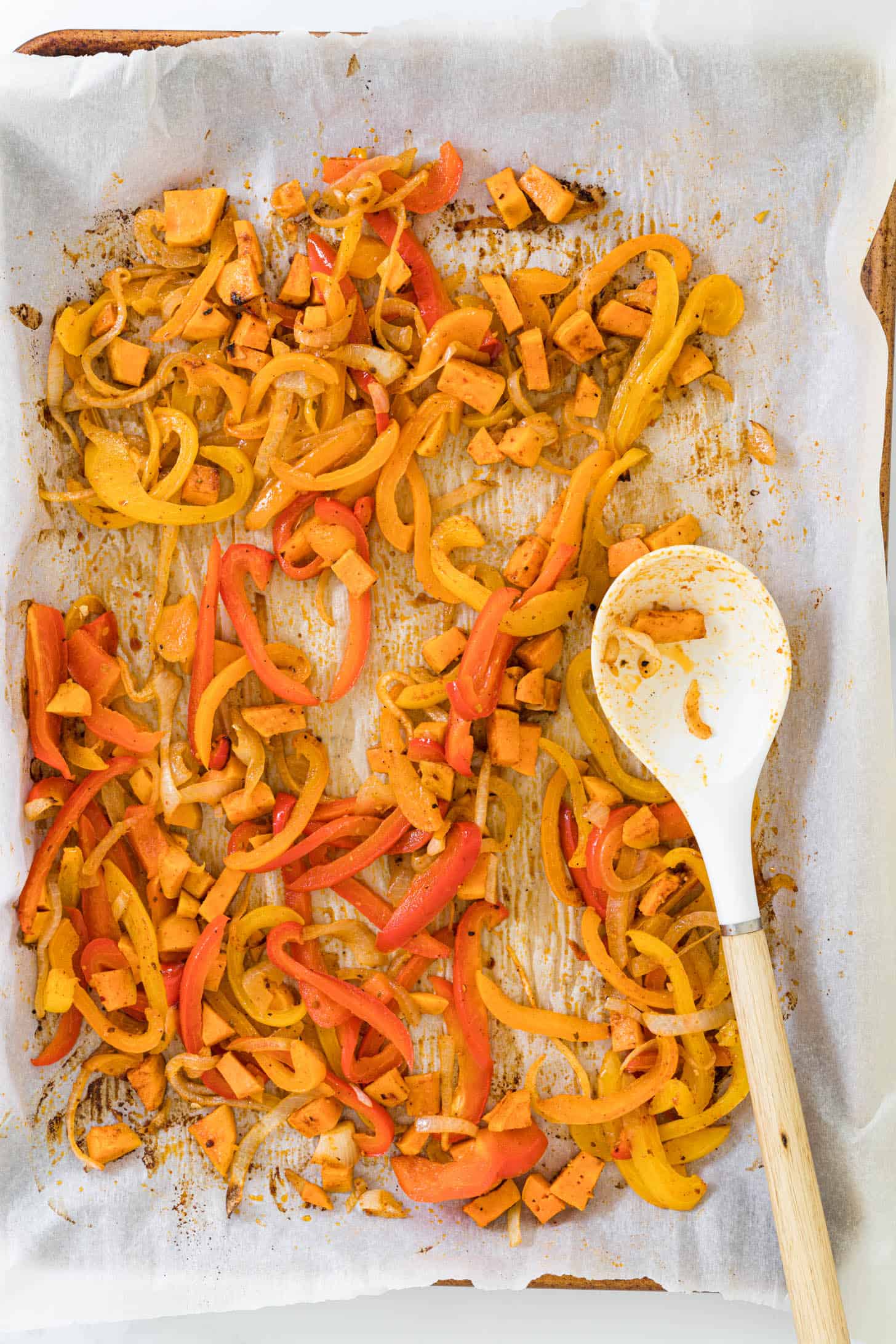 Roasted fajita veggies on a baking sheet.