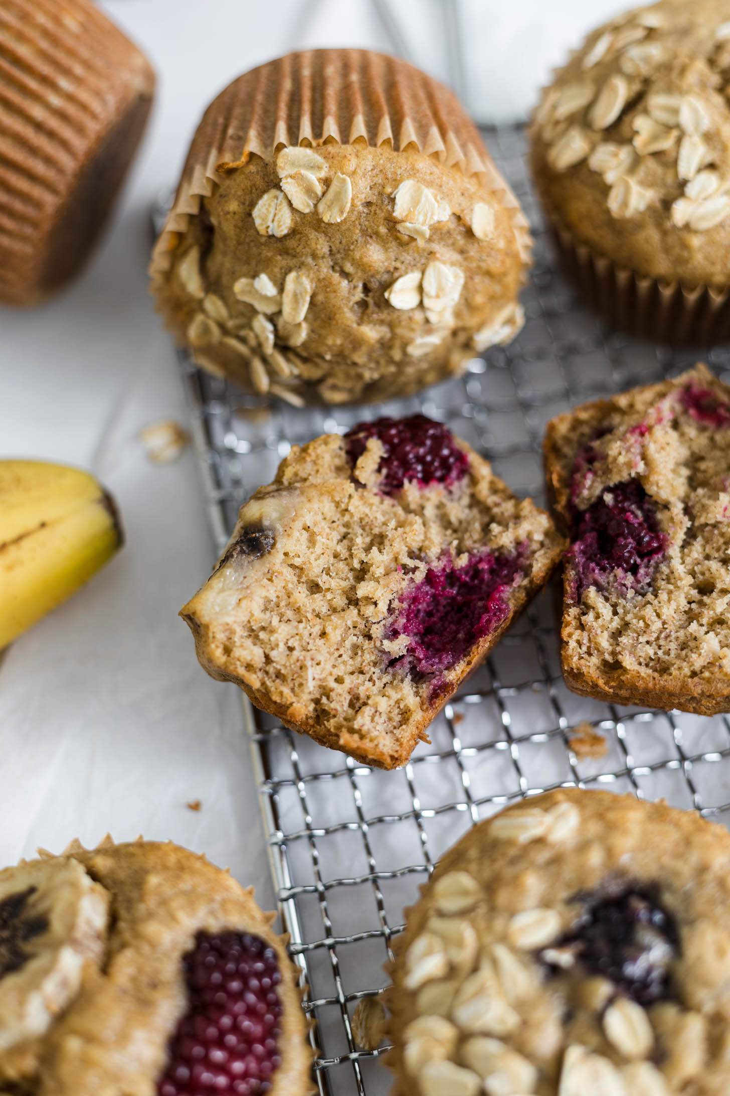 Close up of half of a blackberry muffin laying on it's side.