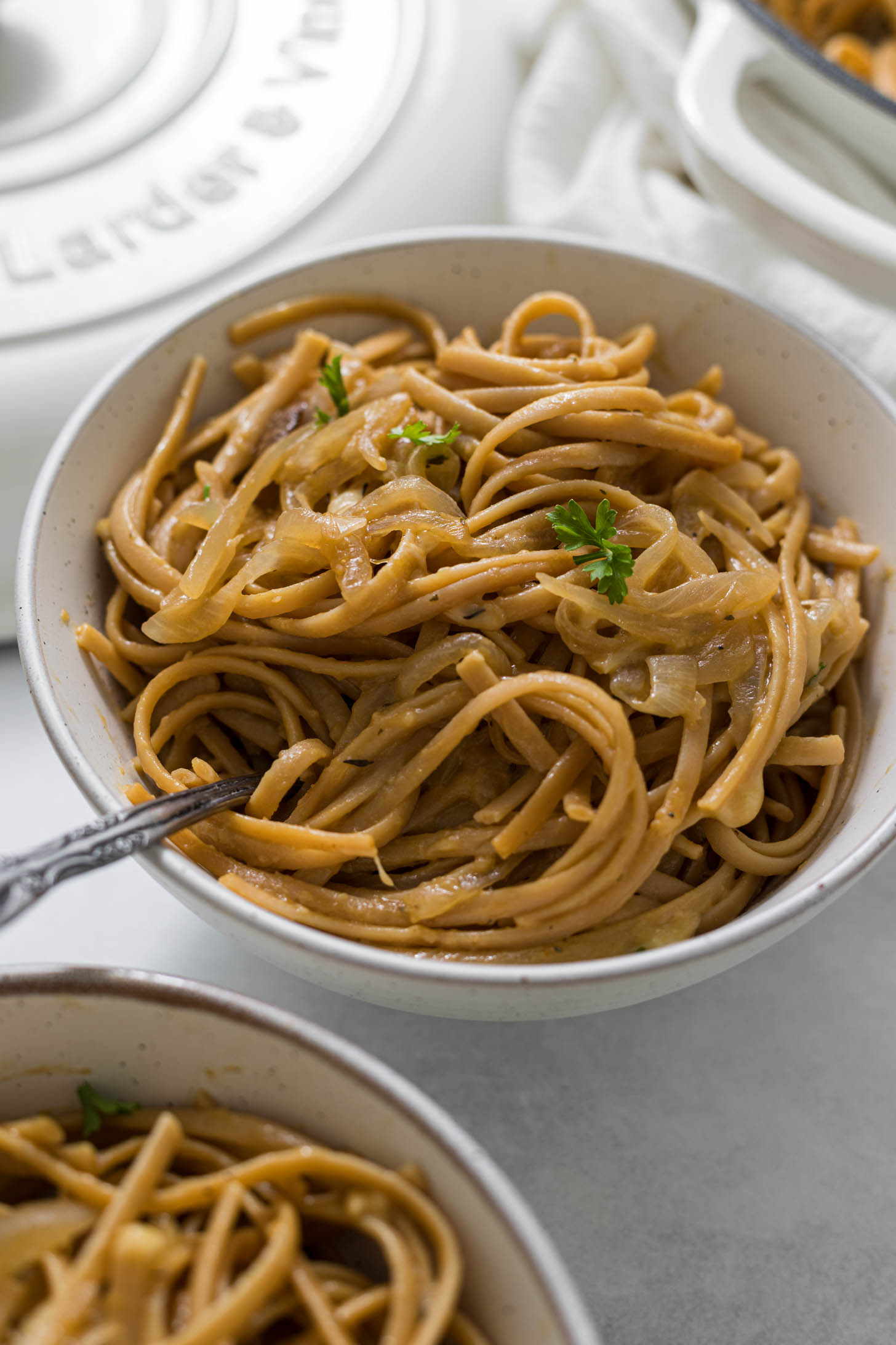 Overhead view of two bowls of one pot french onion pasta.