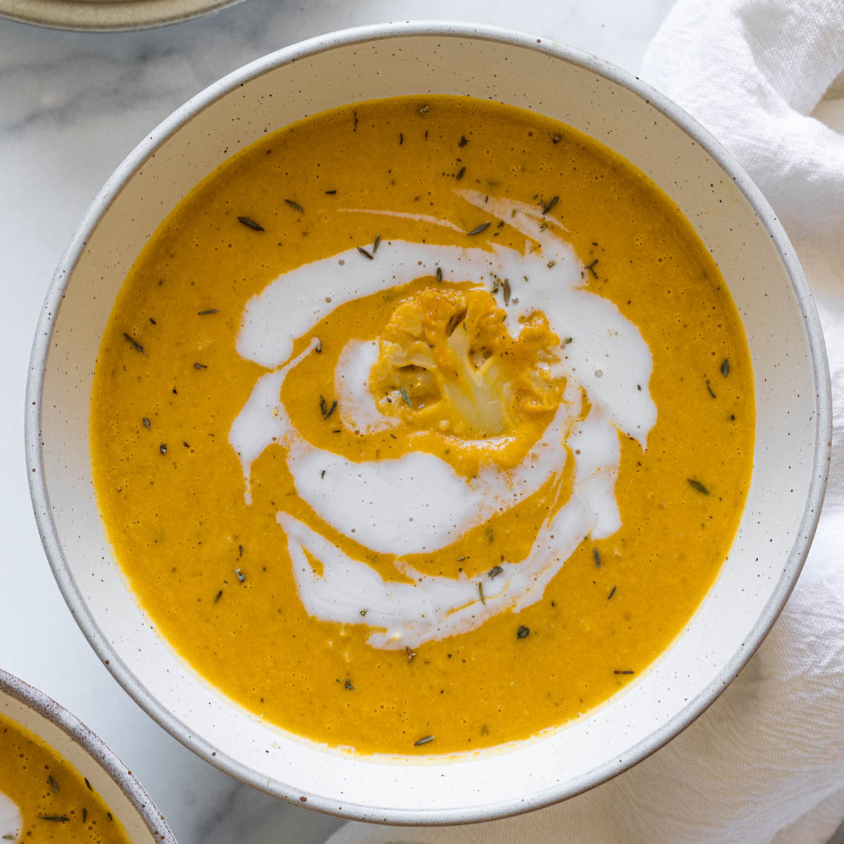 Pumpkin cauliflower soup in a bowl.
