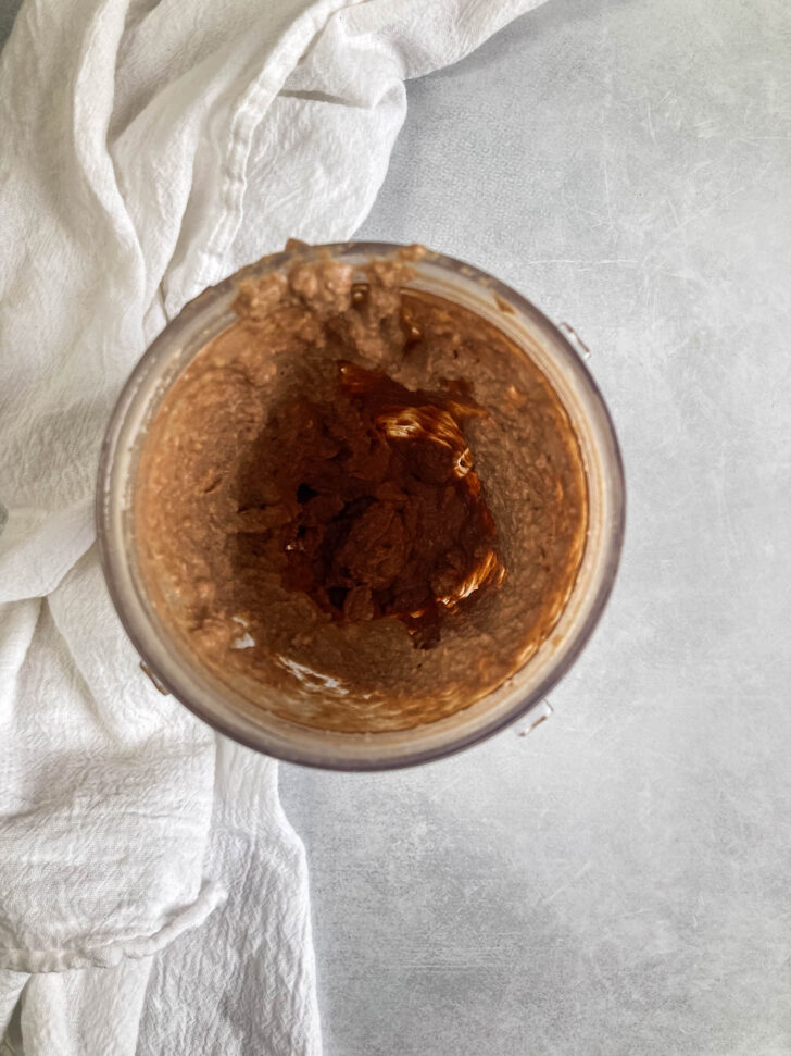 Chocolate hazelnut ingredients blended in a high-speed blender.