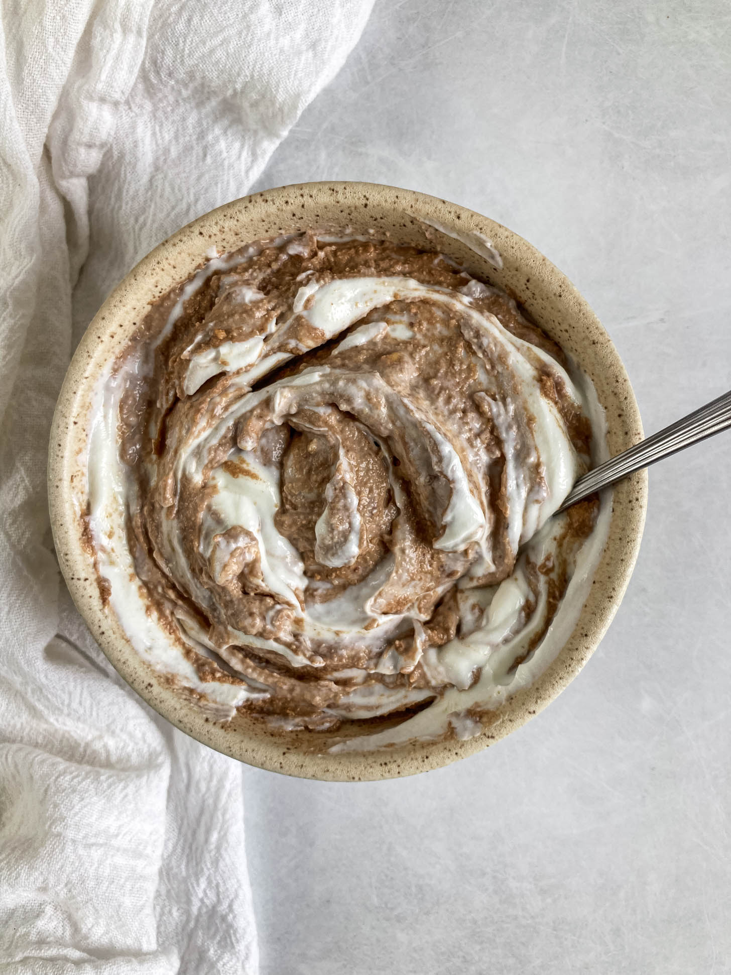 Yogurt and chocolate hazelnut mixture mixed together in a bowl.