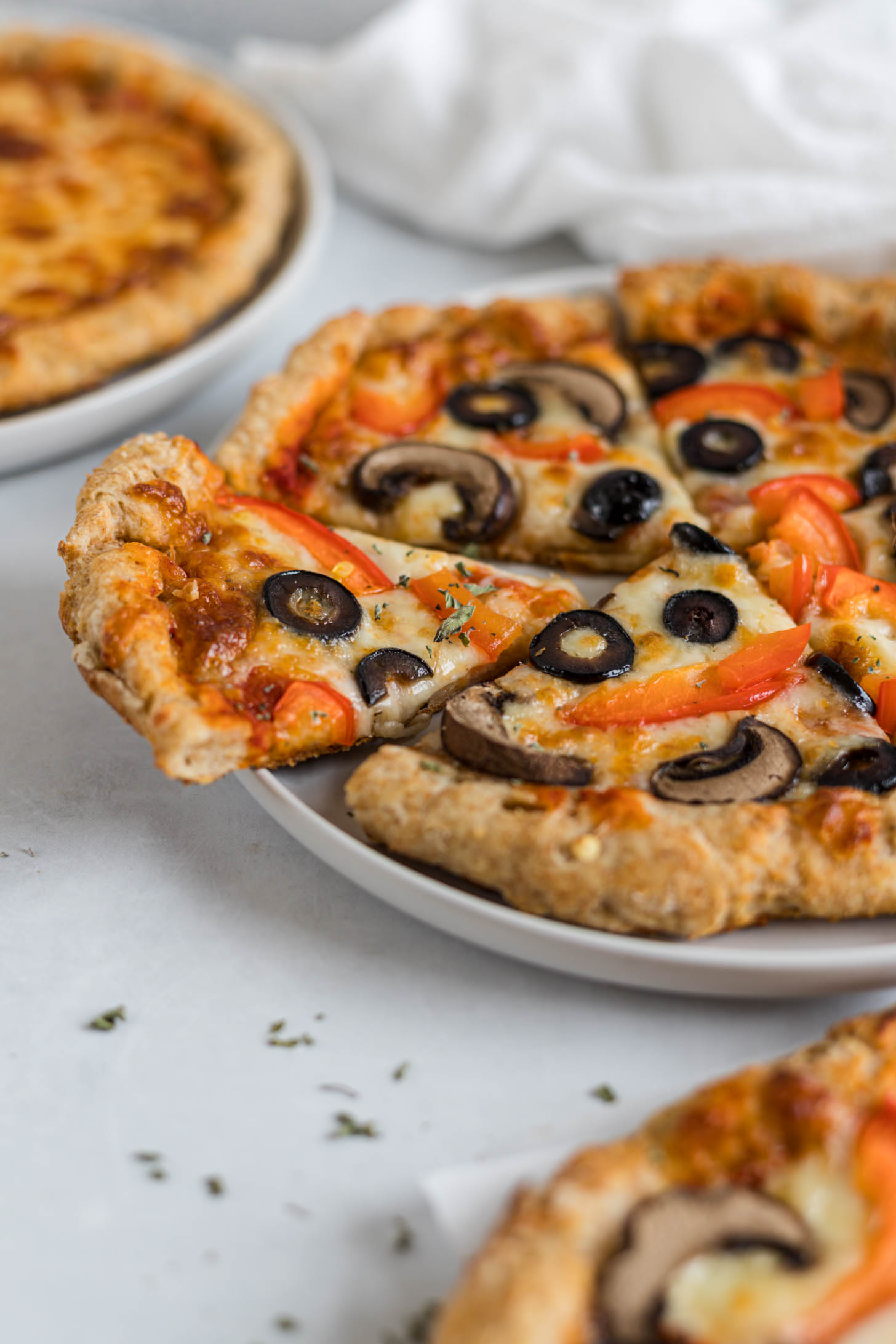 Pizza with veggies on top.