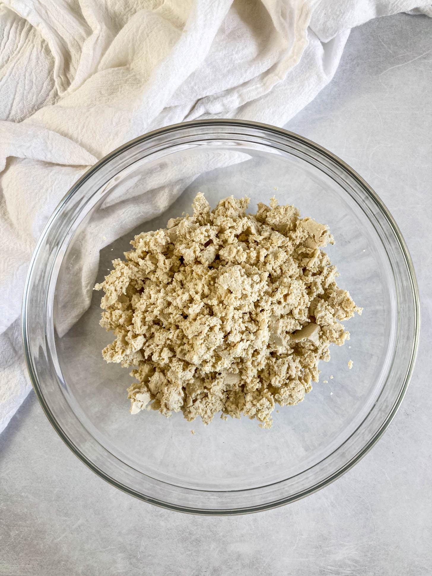 Tofu ground into crumbles in a bowl.