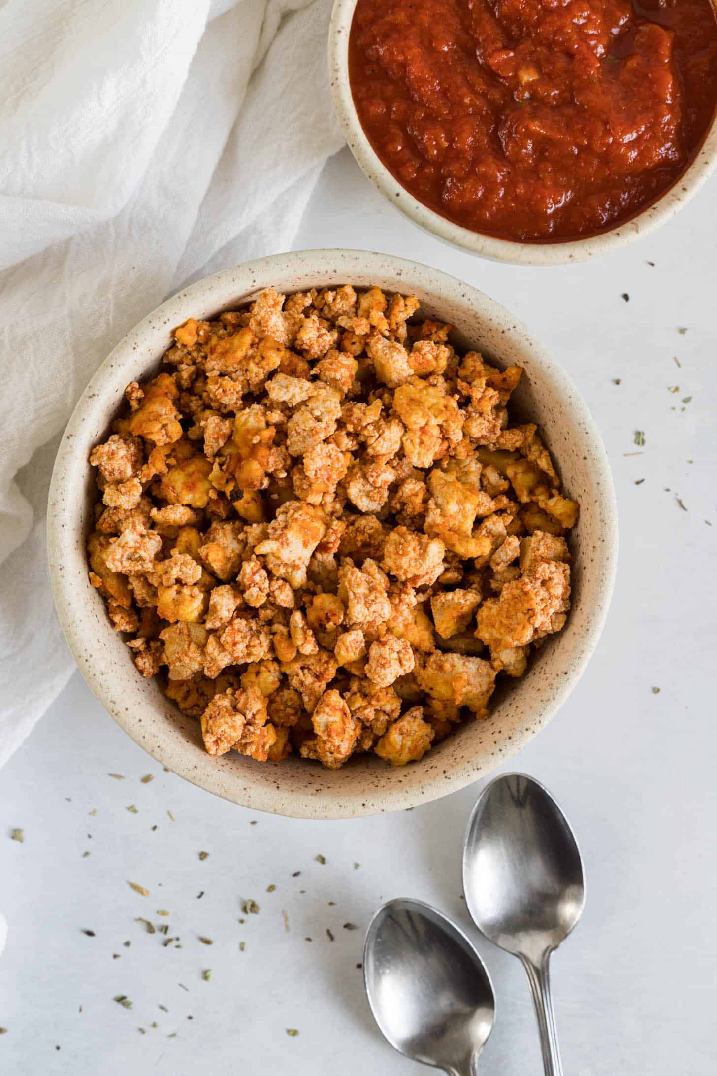 Tofu crumbles with pizza sauce.