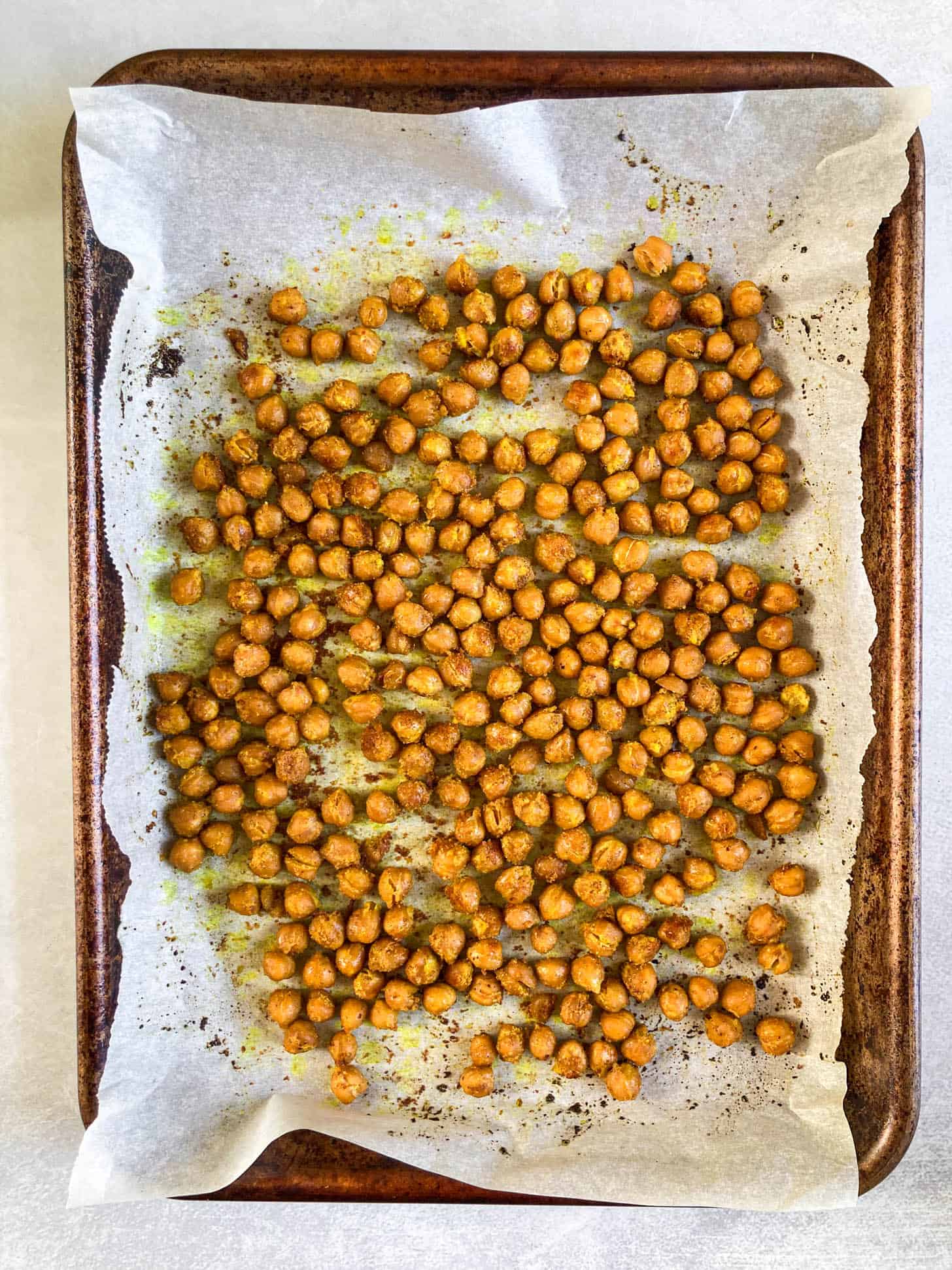 Baked chickpeas on a baking sheet.