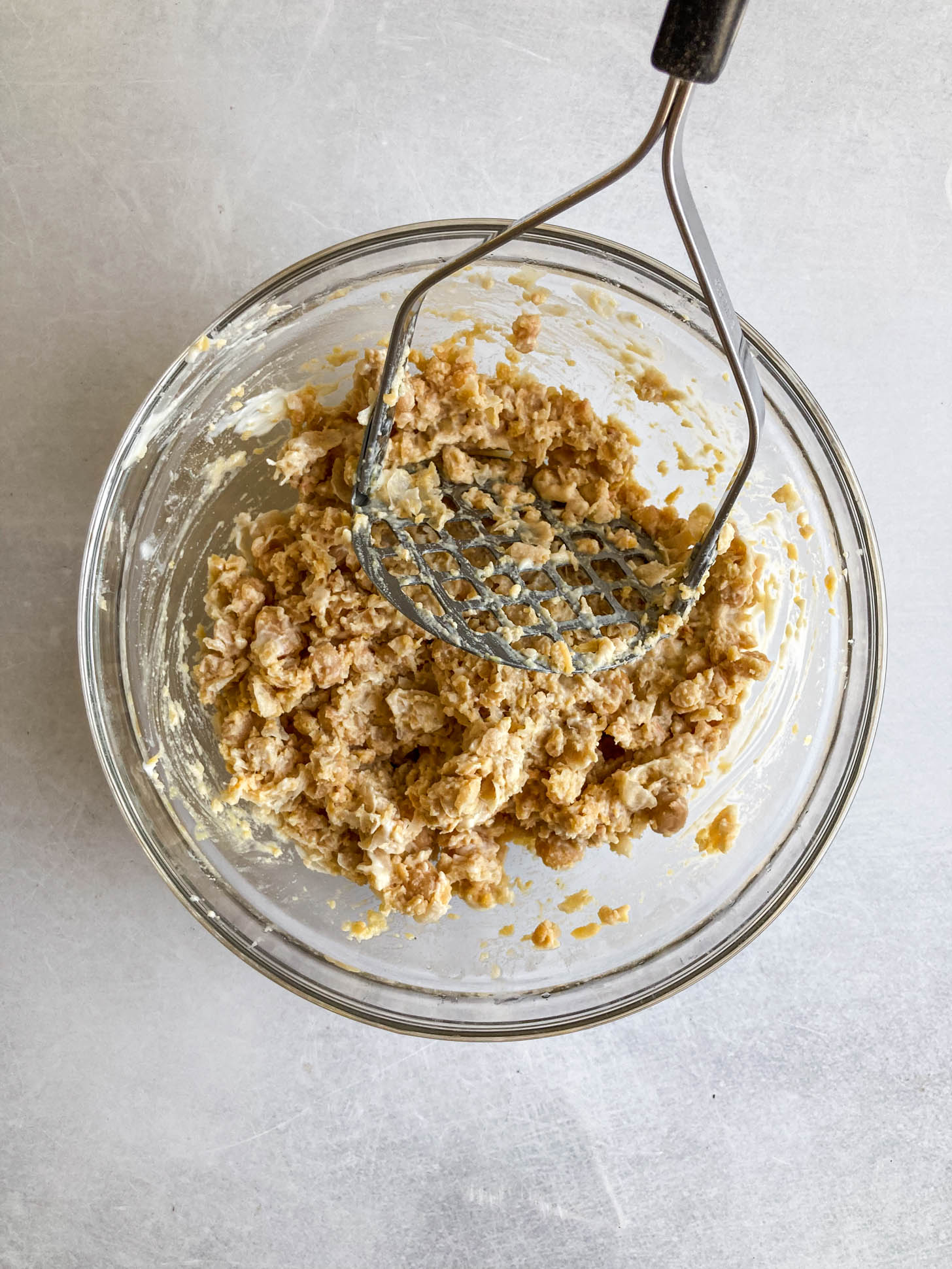 Chickpeas smashed in a bowl.