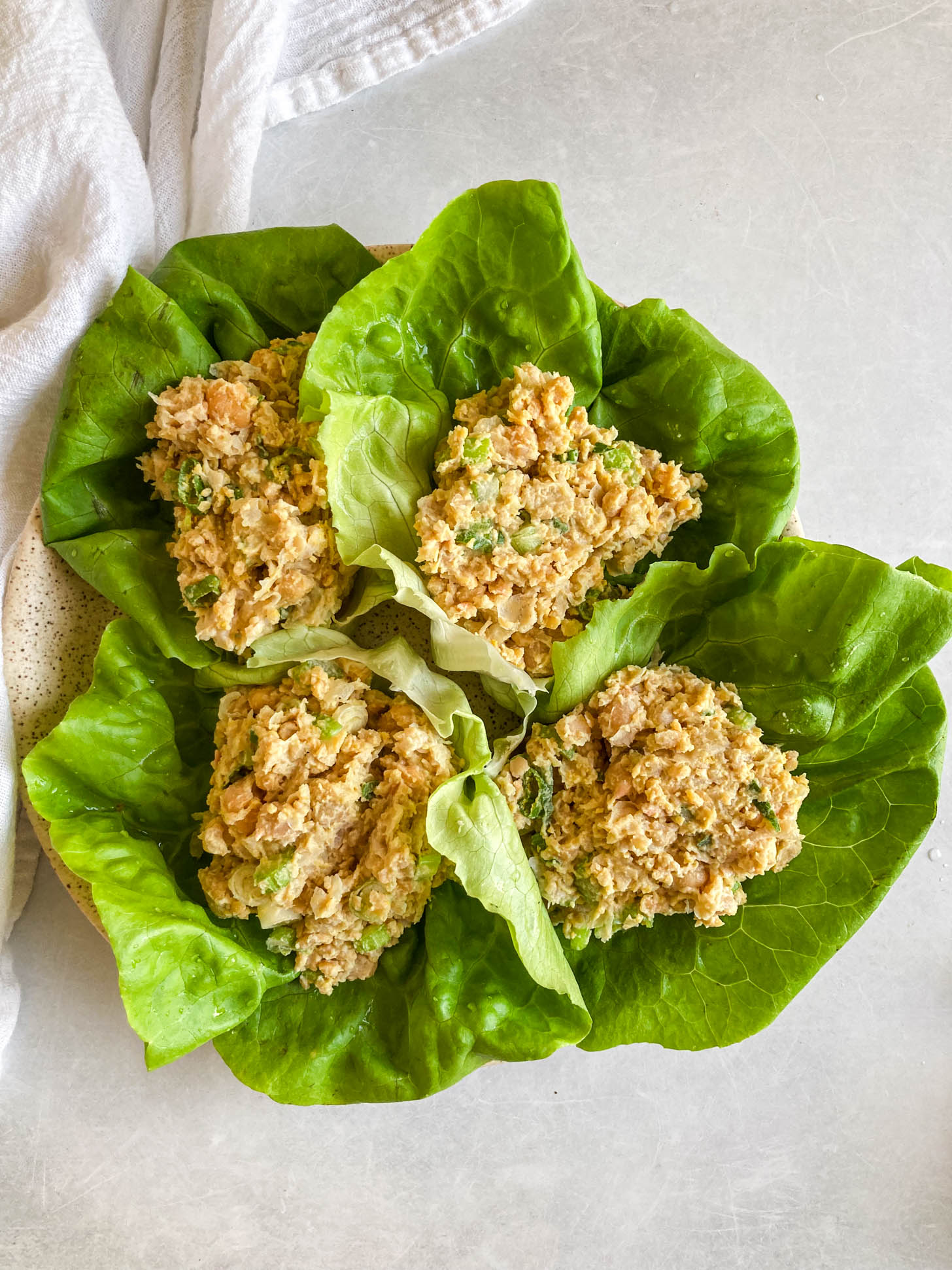 Chickpea salad assembled into lettuce wraps.