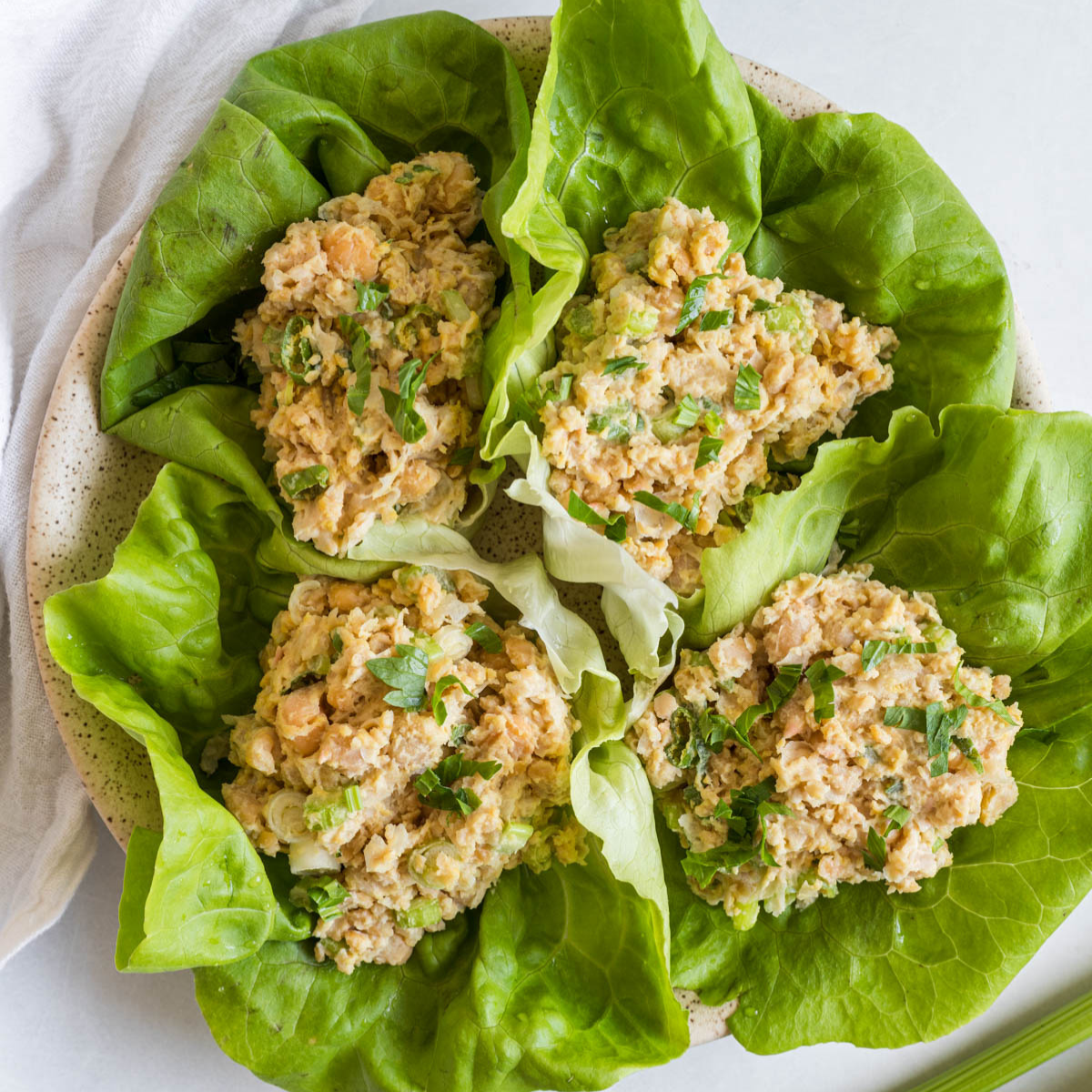 Smashed chickpea salad lettuce wraps on a plate.