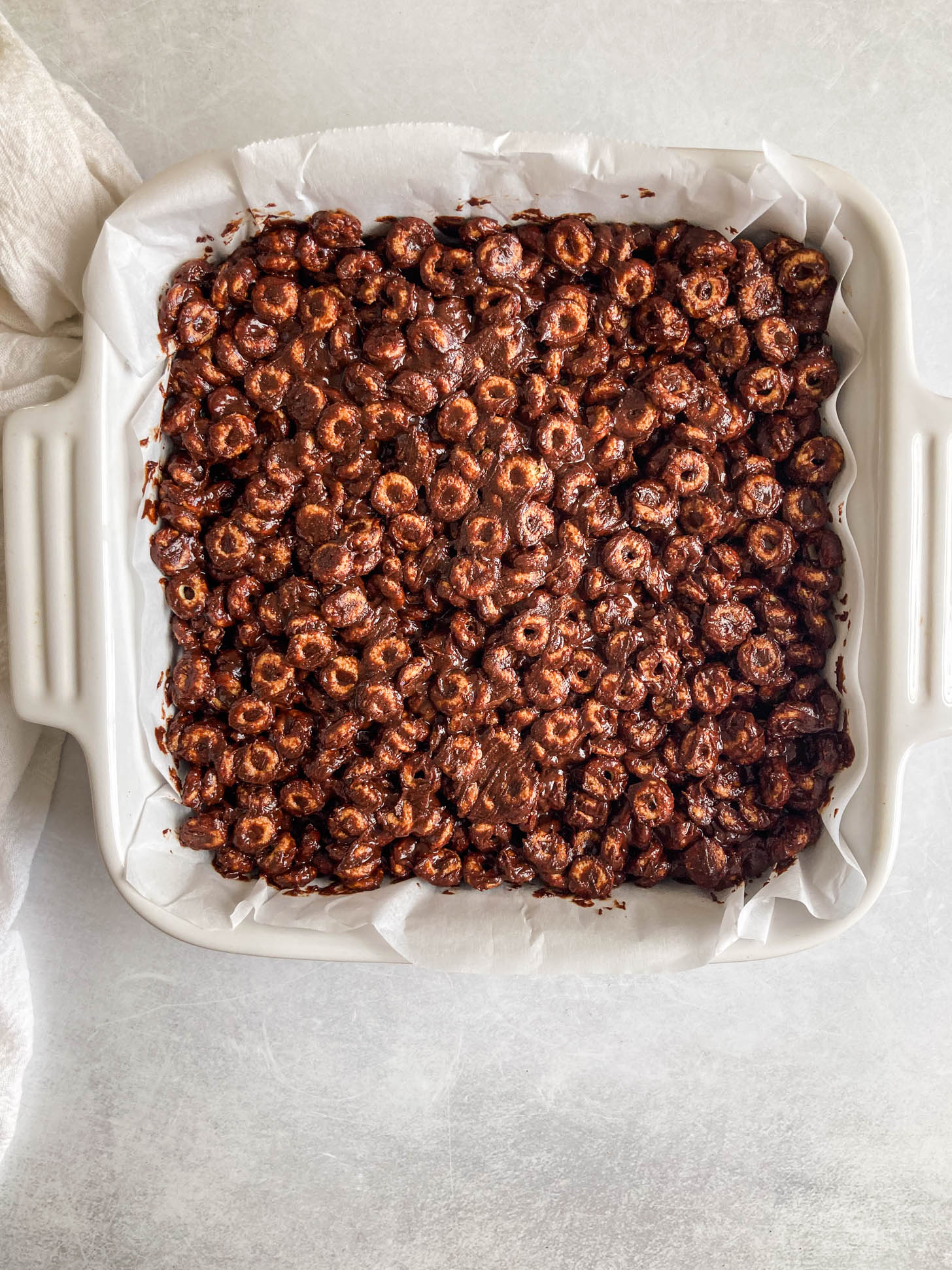 Chocolate cereal mixture in a baking dish.