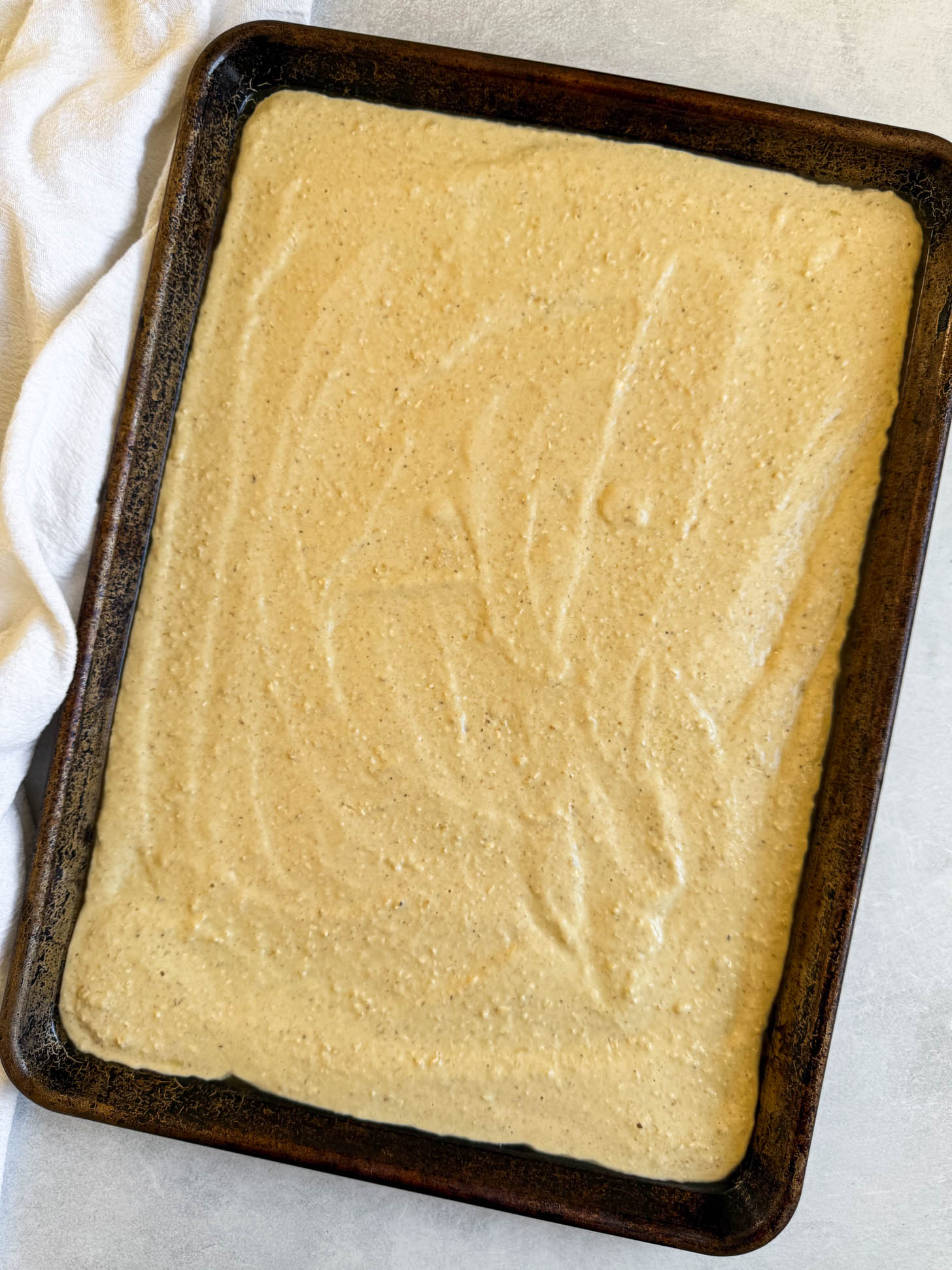 Pancake batter poured onto a baking sheet.