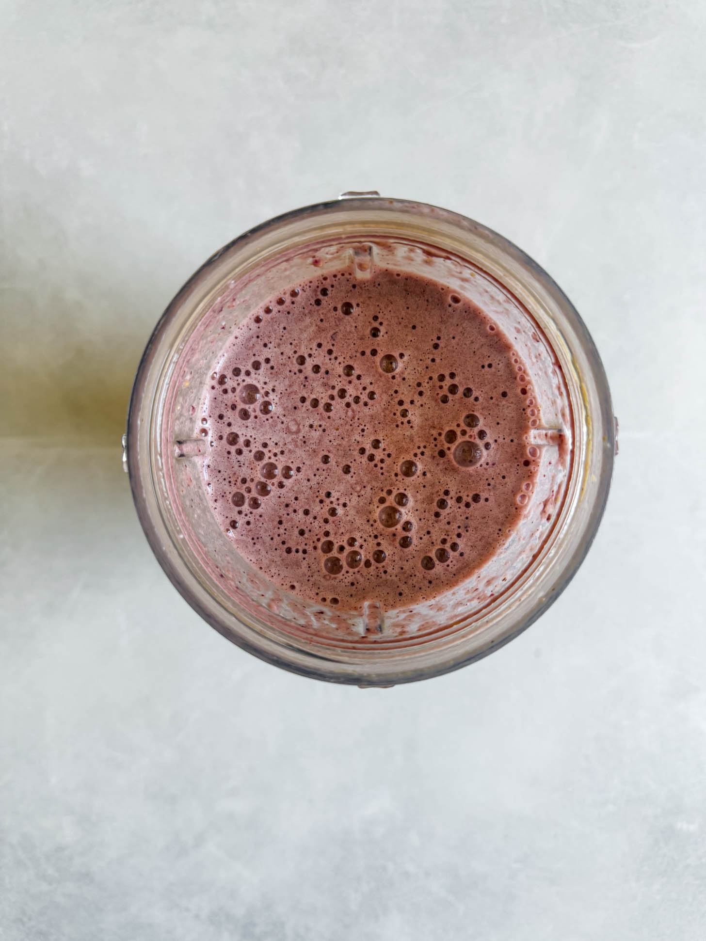 Ingredients blended in a smoothie cup.