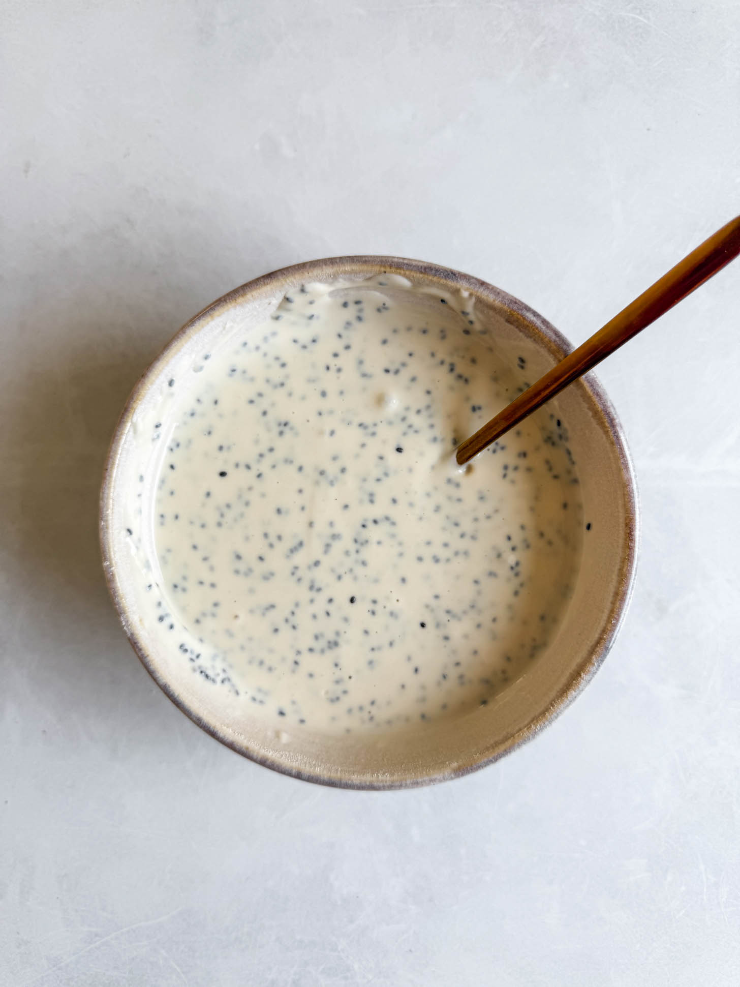 Chia seeds added to the yogurt bowl.