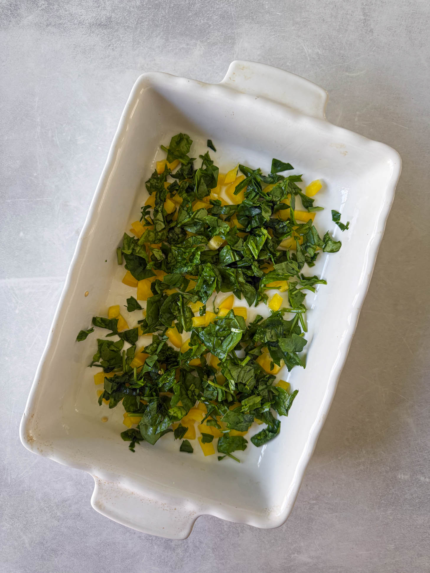 Veggies added to the baking dish.