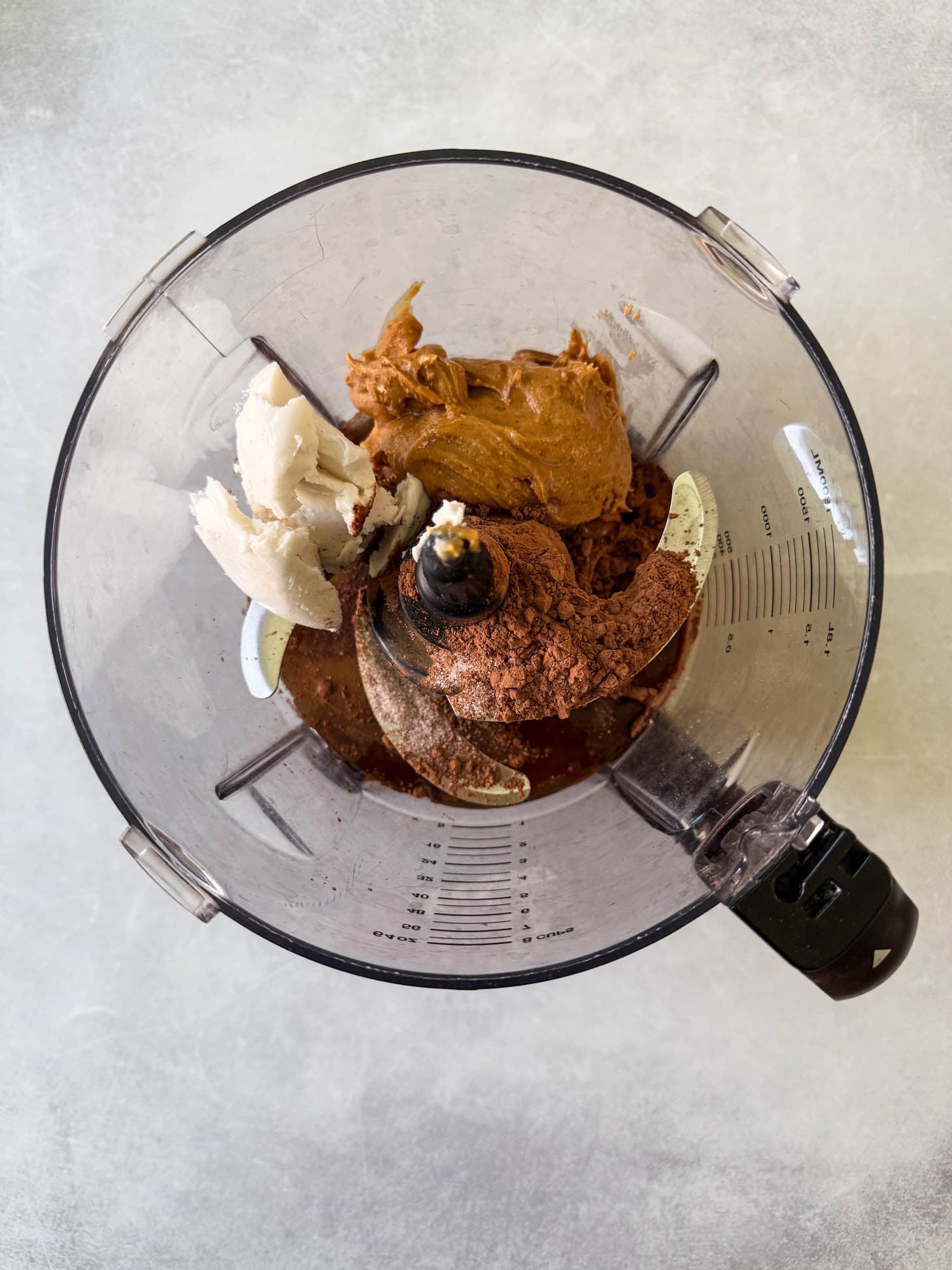 Ingredients being added to a food processor.