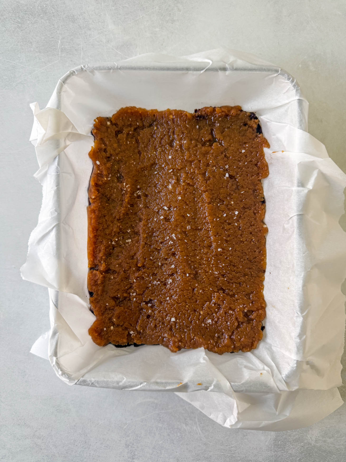 Freezer fudge mixture spread out evenly in baking dish.